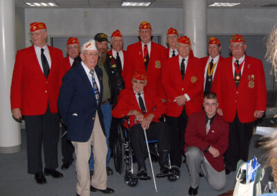 Seacoast Detachment #394 Membership a group of 10 Marine Corps League members in a photo opp for the Guadalcanal Flag presentation to Pease Greeters in 2007.