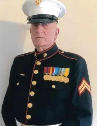 Marine in full uniform with several service medals.