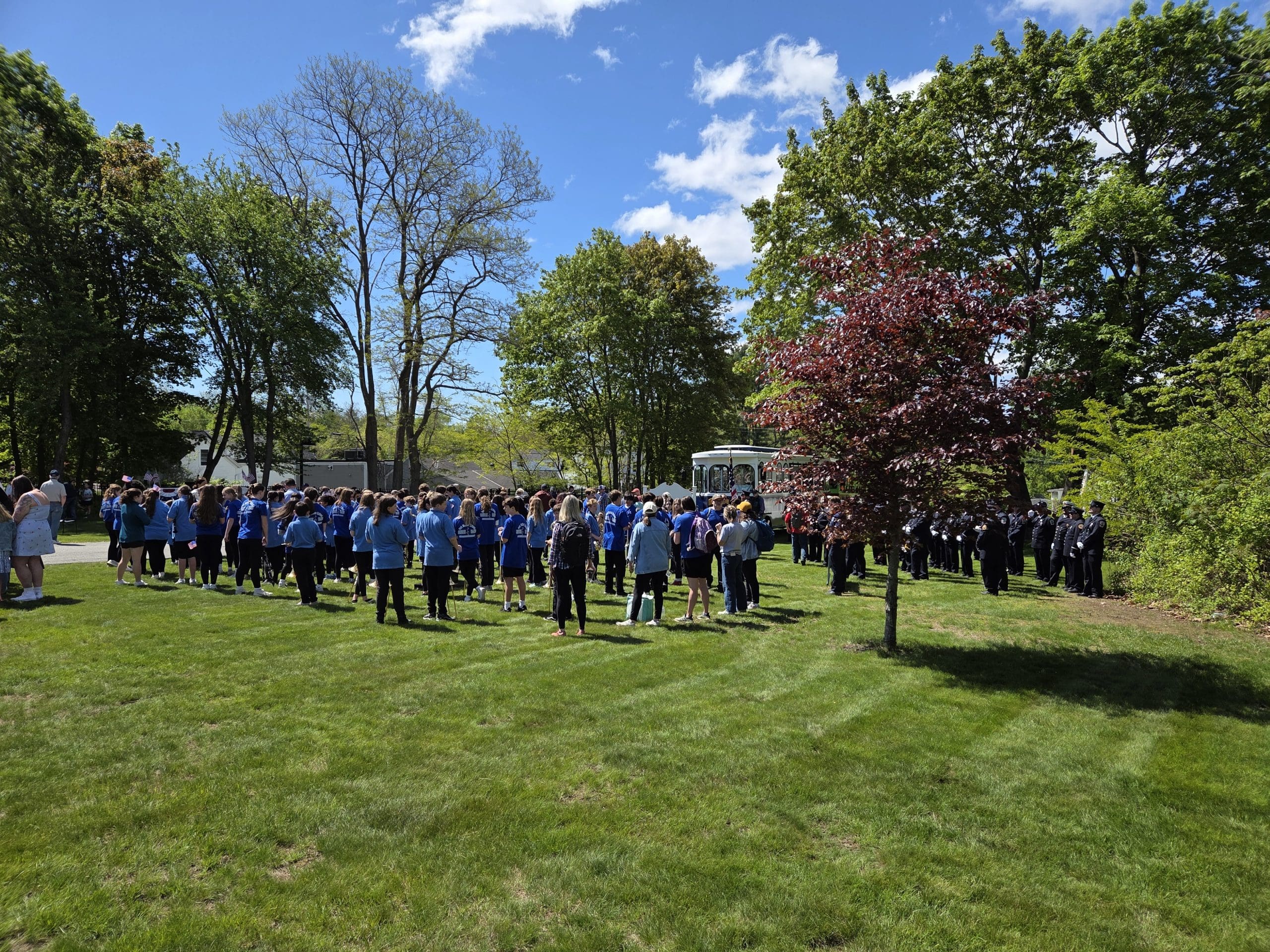 large group of people gather and celebrate the memories of their loved ones lost on Memorial day cemetery event.